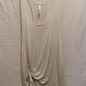 Simple white tank with knot at the bottom.